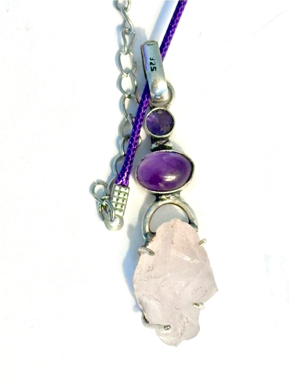 Natural, 2 inch, Rose Quartz on the bottom and 2 Amethyst on a leather chain.
